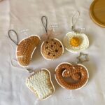 Crochet mini foods which include croissant, pretzel, egg, toast and cookie