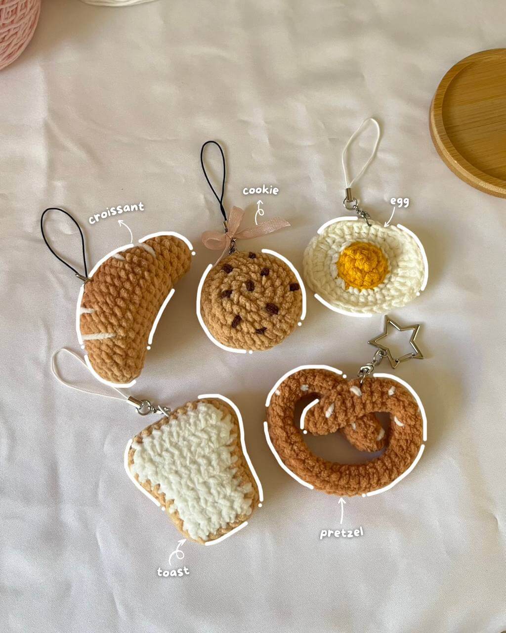 Crochet mini foods which include croissant, pretzel, egg, toast and cookie